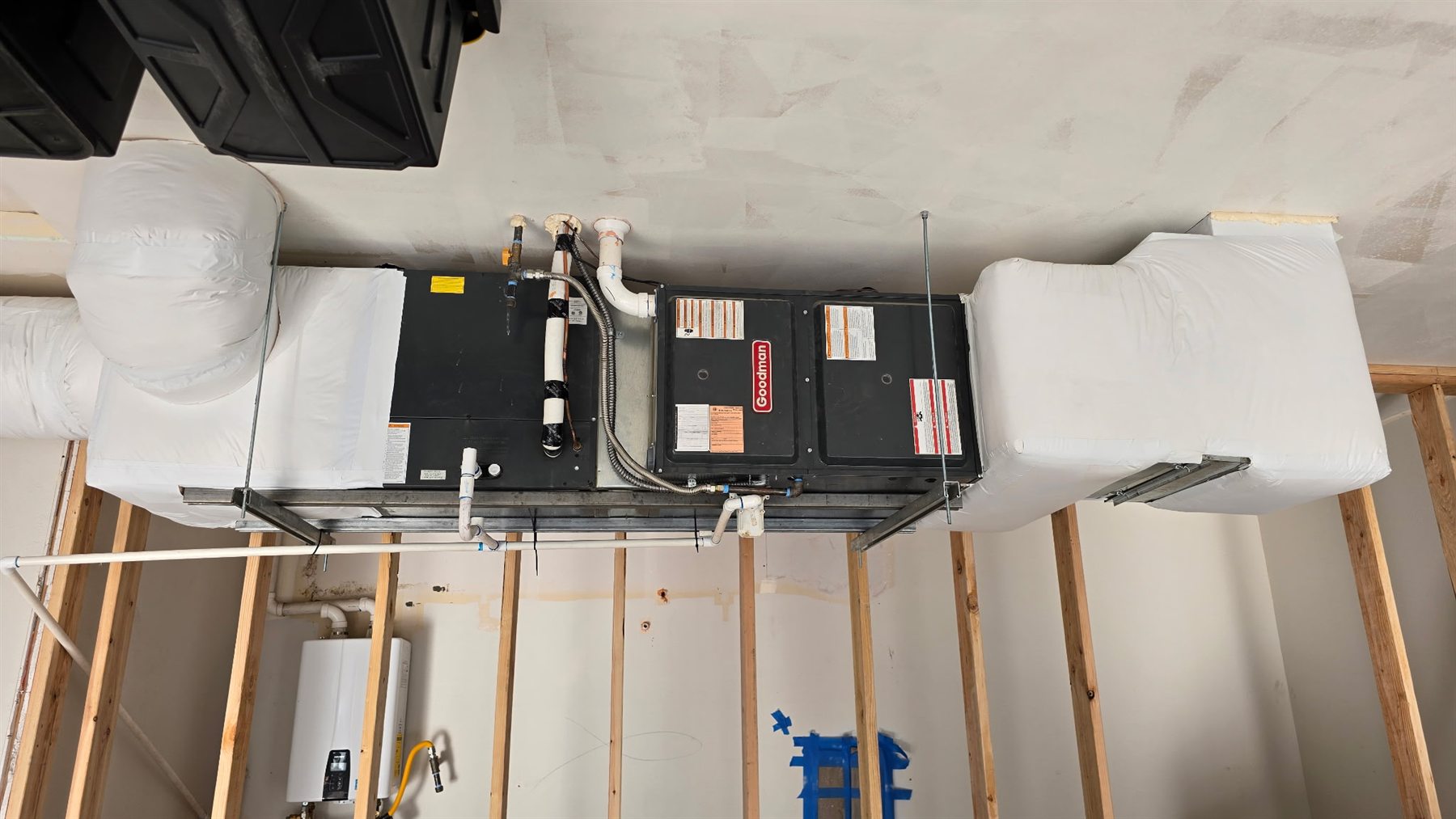 Goodman air handler installed with insulated duct transitions during residential rough-in