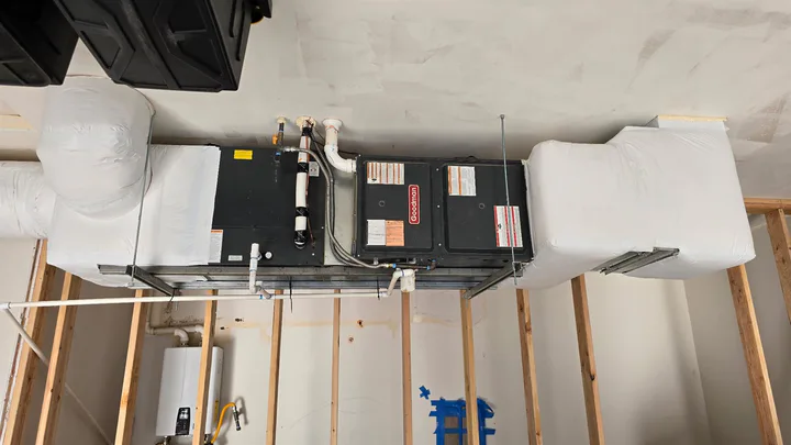 Goodman air handler installed with insulated duct transitions during residential rough-in